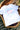 White t-shirt with 'Tell Only Your Best Friends' text on a wooden table.