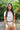 Woman wearing sunglasses and casual outfit in a tropical setting