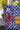 Close-up of a colorful handbag adorned with embroidery and decorative charms.