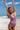 Person in a purple swimsuit enjoying a sunny beach day.