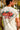 Man wearing a t-shirt with tropical flowers and 'Made For Good Times' print on the back.
