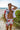 Man in floral beachwear standing by the seaside