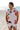Man in floral shirt and shorts on the beach