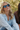 Woman wearing sunglasses sitting outdoors.