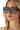 Person wearing large square sunglasses with gradient lenses.