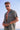 Man in leopard print shirt and sunglasses by the beach