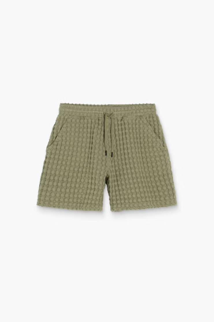 Green checkered shorts on a white background