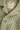 Close-up of a textured green garment with a brand label on a matching background