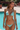 Woman in a turquoise bikini standing by a pool