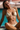 Woman in a beige bikini sitting by a pool